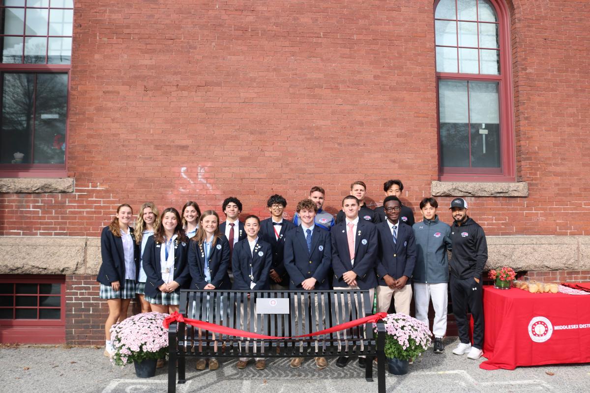 Lowell Catholic School Students behind the "Happy to Chat" Bench 