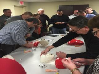 College and University Police Officers engage in a hands-on session that provided practical experience with administering Narcan