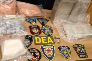 Photo of fentanyl, pills and police badges