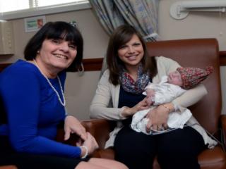 Middlesex DA Ryan visits with new mom Wendy Giblin and baby John, patients at Winchester Hospital
