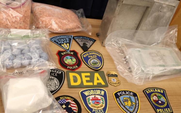 Photo of fentanyl, pills and police badges